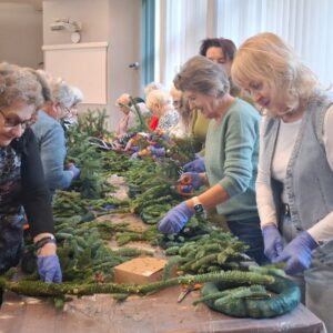Uczestniczki warsztatów florystycznych tworzące iglaste girlandy
